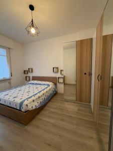 a bedroom with a bed and a large mirror at Zuly House in Savona