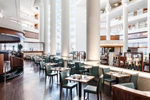 a restaurant with tables and chairs in a building at InterContinental David Tel Aviv by IHG in Tel Aviv