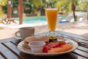 a plate of food and a drink on a table at TecnoHotel Valladolid in Valladolid