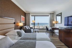 a hotel room with a bed and a view of the ocean at InterContinental David Tel Aviv by IHG in Tel Aviv