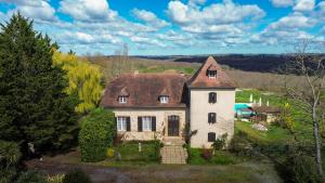 an old white house with a brown roof at Pure Gardères in Monlezun
