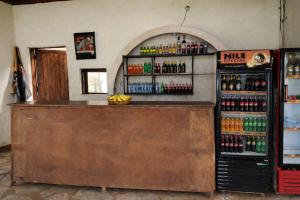 a bar in a room with a bunch of drinks at Masaka Backpackers, Tourists Cottage & Campsite in Masaka