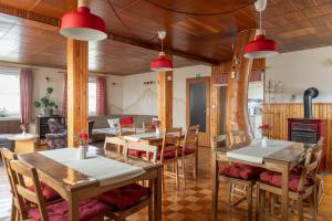 a dining room with wooden tables and chairs at Gorski biser in Mojstrana