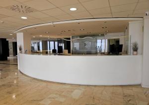 an office with a large white counter in a lobby at Hotel & Spa Peñiscola Palace in Peniscola +37 photos