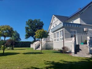 a large white house with a large yard at Pension Onken in Bockhorn