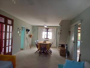 a living room with a table and a window at Appartement spacieux étage maison avec jardin à Ste Anne in Sainte-Anne