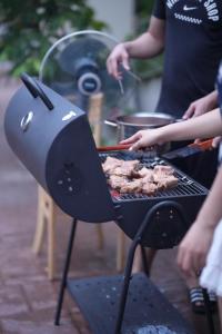 a person is cooking food on a grill at Rosemary's in Ha Long