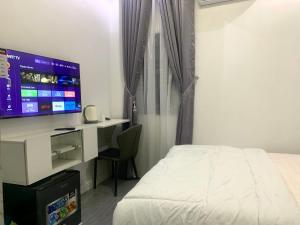 a bedroom with a bed and a desk with a computer at Ehi-Mega Luxury Hotel and Apartment in Abuja