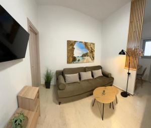 a living room with a couch and a table at Yanna's Apartments in Sidari