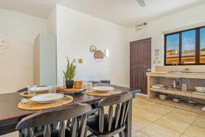 a kitchen with a table with chairs and a sink at Garza 912 in Carpintero