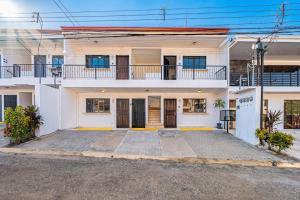 a large white house with a balcony at Garza 912 in Carpintero