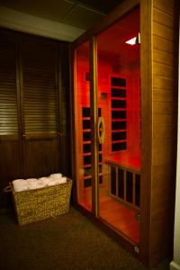 a glass door to a shower with a basket in a room at Whole House Aurora View with Hot tub, Sauna and AC in Fairbanks