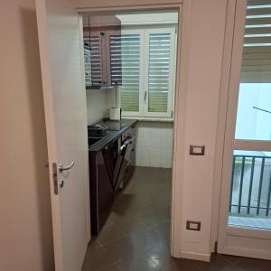 a kitchen with a sink and a stove at Quasi in Cattedrale, nel cuore storico di Asti in Asti