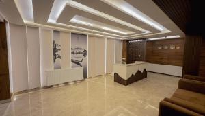 a lobby with a reception desk in a building at The Royal Luxe in Kolur