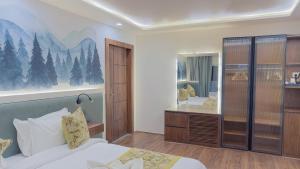 a bedroom with a bed and a mirror at The Royal Luxe in Kolur +25 photos