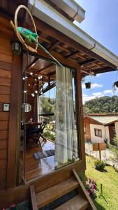 a screened in porch with a view of a house at Chalé Beijinho in Venda Nova do Imigrante