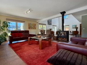 a living room with couches and a table and a fireplace at Casa Carvalhal - Adults Only in Góis