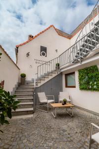 a patio with a table and stairs in front of a building at Townhouse Boutique in Sibiu