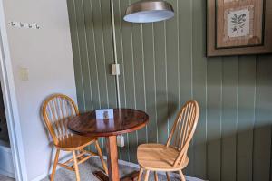 a wooden table and two chairs and a table and a table at Seasons 103 in Warren