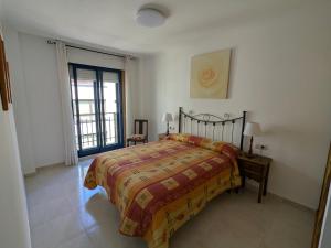 a bedroom with a large bed and a window at L&C Codesal in Sanxenxo