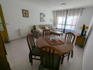 a living room with a table and chairs and a couch at L&C Codesal in Sanxenxo