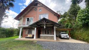 a house with a car parked in front of it at Relax Home in Puyo