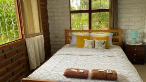 a bedroom with a bed with two slippers on it at Relax Home in Puyo