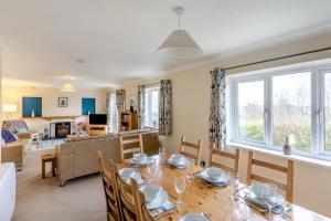a dining room and living room with a table and chairs at 4 Bed in Croyde oc-sundow in Croyde