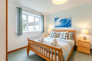 a bedroom with a wooden bed and a window at 4 Bed in Croyde oc-sundow in Croyde
