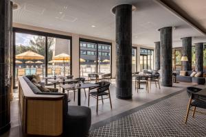 a restaurant with tables and chairs and columns at Radisson Blu Hotel, Florence in Florence