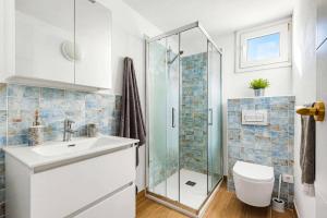 a bathroom with a shower and a sink and a toilet at Villa Adelaide by Villa Plus in Sant Lluis +20 photos