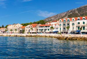 a group of buildings next to a body of water at Apartment Desa in Bol