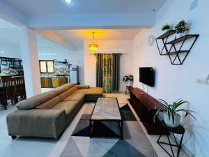 a living room with a couch and a table at L'Appart des Amis in Antsiranana