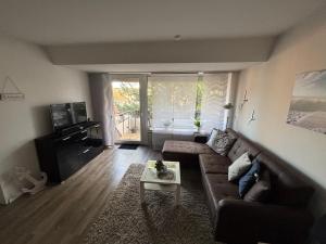 a living room with a couch and a table at Ankerplatz Niendorf in Timmendorfer Strand