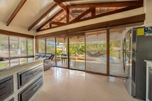 a kitchen with sliding glass doors leading to a patio at Villa Sol 23 in Playa Hermosa