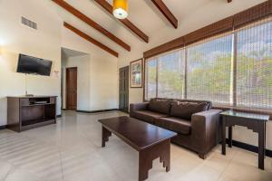 a living room with a couch and a coffee table at Villa Sol 23 in Playa Hermosa
