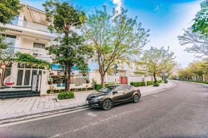 a car parked on the side of a street at Happy Villa in Sầm Sơn