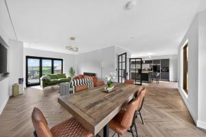 a living room with a wooden table and chairs at Heddfan in Carmarthen