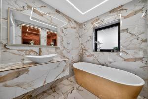 a bathroom with a tub and a sink and a mirror at Heddfan in Carmarthen +38 photos