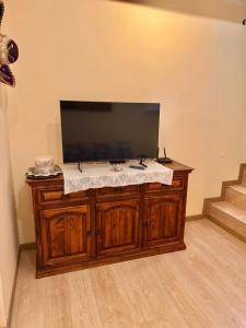 a flat screen tv sitting on top of a wooden cabinet at Residenza il Sole in Bologna