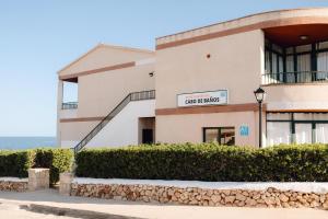 a building with a sign for a car dealership at BLUESEA Cabo de Baños in Cala en Blanes