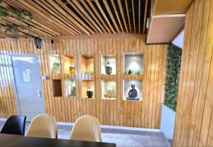 a room with wooden walls and shelves with plants at BLUESEA Torremolinos Centro in Torremolinos