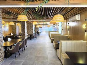 a dining room with tables and chairs and chandeliers at BLUESEA Torremolinos Centro in Torremolinos