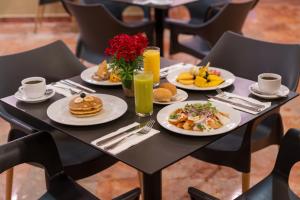 a table with plates of breakfast food on it at Grand Oasis Palm - All inclusive in Cancún