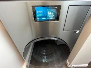 a washing machine with a tv on top of it at South Robins Retreat in Warner Robins