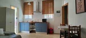 a kitchen with a blue cabinet and a table at Apartamento Katy in Seville