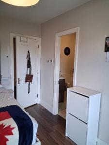 a bedroom with a bed and a dresser and a closet at Bedroom in Blanchardstown in Blanchardstown