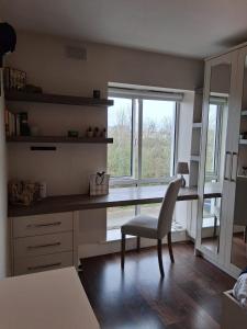 a desk with a chair and a window in a room at Bedroom in Blanchardstown in Blanchardstown