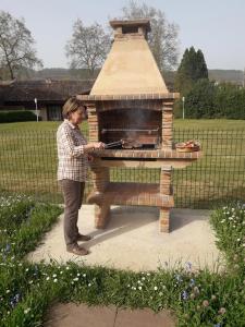 a woman standing in front of a brick oven at LOPENEA Baztan in Garzáin