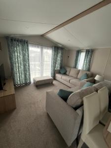a living room with couches and a large window at Tayock Park in Montrose